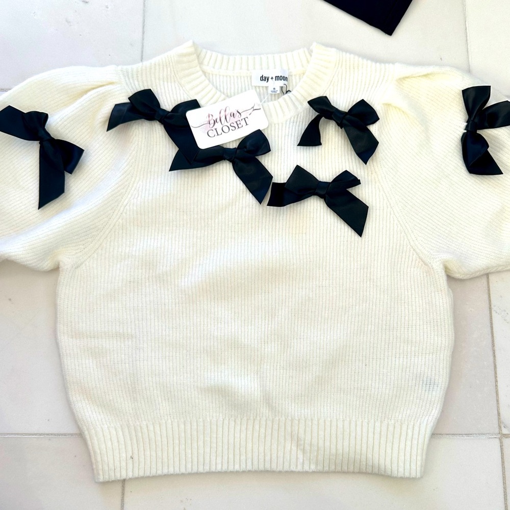 Cream sweater, black bows